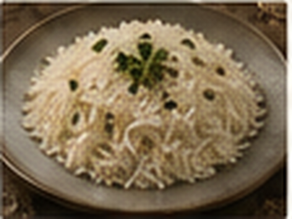 Steamed basmati rice served with herbs in a premium NAZIA recipe setting